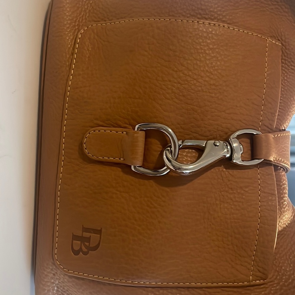 Dooney and Bourke light tan buckle handbag